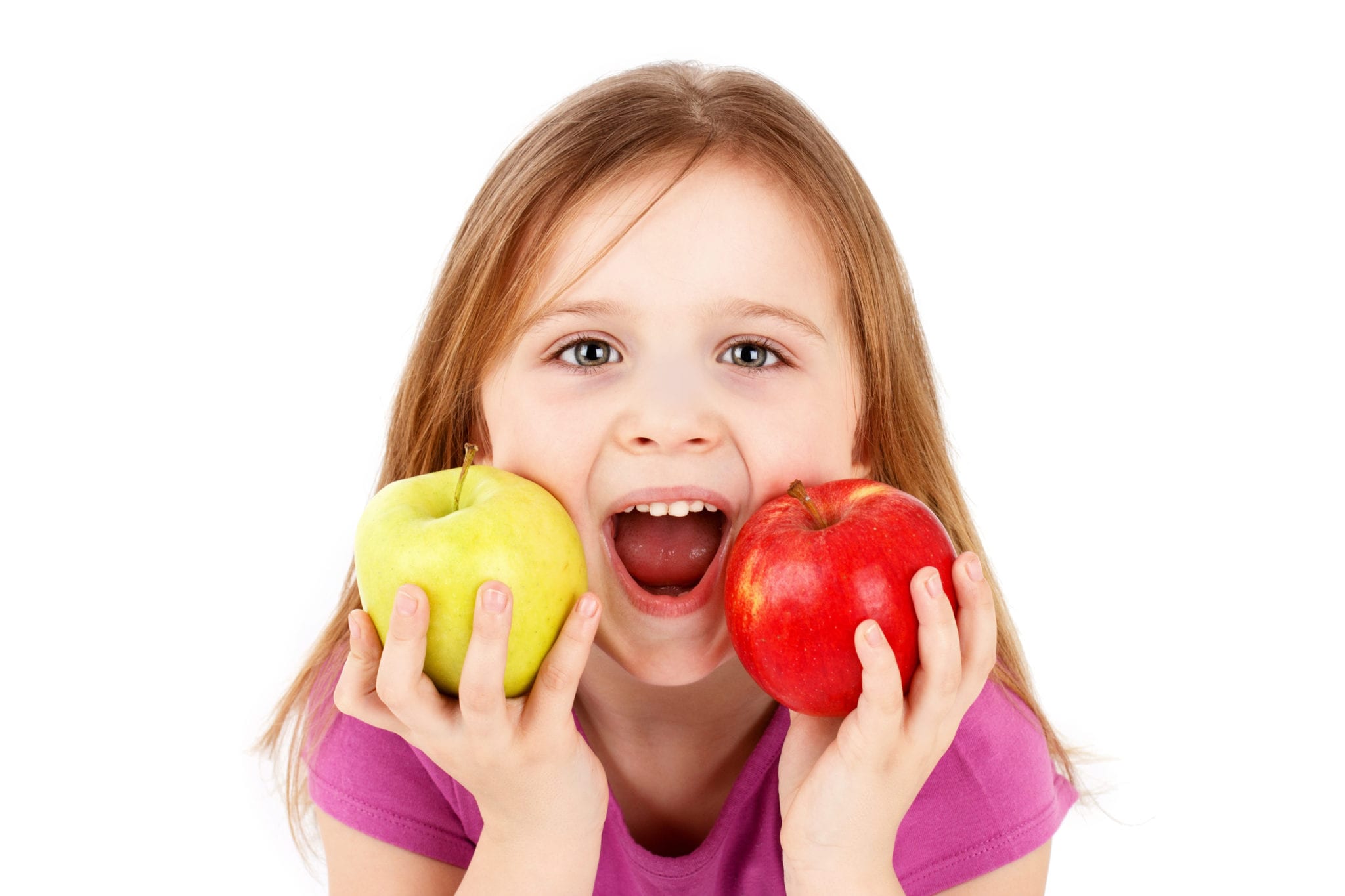 Funny little girl eating apples